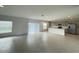 Open-concept living space featuring tile floors, large windows, and modern kitchen at 228 Aquamarine Ln, Kissimmee, FL 34758