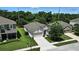 An aerial view of a home with a well-manicured lawn and professional landscaping at 2718 Limerick Cir, Grand Island, FL 32735