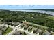 Aerial view of home and neighborhood near a tranquil lake with lots of trees around at 2718 Limerick Cir, Grand Island, FL 32735
