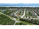 Aerial view of the home and neighborhood, highlighting the location near a lake and tree line at 2718 Limerick Cir, Grand Island, FL 32735