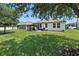 Lush backyard featuring a screened patio and ample space for outdoor enjoyment at 2718 Limerick Cir, Grand Island, FL 32735