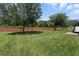 Expansive backyard enclosed by a brick wall, offering privacy and space at 2718 Limerick Cir, Grand Island, FL 32735