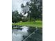 Community outdoor basketball court with well kept lawn and a large shady tree at 2718 Limerick Cir, Grand Island, FL 32735