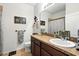 Bathroom features a granite countertop, modern fixtures, and a decorative mirror for added style at 2718 Limerick Cir, Grand Island, FL 32735