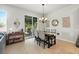 Dining room features a chandelier, decor, and sliding glass door leading to the outdoor patio at 2718 Limerick Cir, Grand Island, FL 32735