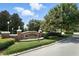 Grand Island Reserve entrance sign with lush landscaping and brick pillar with light fixtures at 2718 Limerick Cir, Grand Island, FL 32735