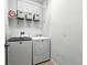 Efficient laundry room with modern washer and dryer and storage shelves at 2718 Limerick Cir, Grand Island, FL 32735