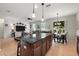 Open-concept floor plan, showcasing the kitchen island, dining area, and living room at 2718 Limerick Cir, Grand Island, FL 32735