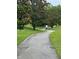 Paved walking path through a lushly landscaped area, perfect for a leisurely stroll at 2718 Limerick Cir, Grand Island, FL 32735