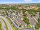 Aerial view of a community with townhomes, a lake, a highway, parking and a tree lined landscape at 2739 N Poinciana Blvd # 77, Kissimmee, FL 34746