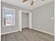 This bedroom features hardwood floors, neutral paint, and a closet for storage at 2739 N Poinciana Blvd # 77, Kissimmee, FL 34746
