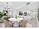 Modern dining area with stylish lighting, seating, and a seamless flow into the kitchen space at 2739 N Poinciana Blvd # 77, Kissimmee, FL 34746