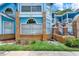 A close-up exterior of a two-story condo showcases brick accents and well-maintained landscaping at 2739 N Poinciana Blvd # 77, Kissimmee, FL 34746