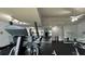 Fitness center featuring a variety of gym equipment, mirrored walls, and ceiling fans at 2739 N Poinciana Blvd # 77, Kissimmee, FL 34746