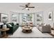 Bright living room with a ceiling fan, bay window, and comfortable furnishings, perfect for relaxation at 2739 N Poinciana Blvd # 77, Kissimmee, FL 34746
