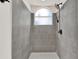 Modern shower with gray tiled walls, an arched window, and a rain shower head at 2739 N Poinciana Blvd # 77, Kissimmee, FL 34746