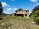 Exterior of the two story home from the backyard with a patio, grass, and shed at 281 Covent Gardens Pl, Deltona, FL 32725