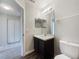 Well-lit bathroom featuring a single sink vanity with a mirror and a toilet at 281 Covent Gardens Pl, Deltona, FL 32725