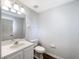 Bathroom featuring a toilet, vanity, mirror, and towel rack at 281 Covent Gardens Pl, Deltona, FL 32725
