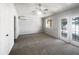 Bright bedroom with neutral walls, carpet, ceiling fan and access to an outdoor balcony at 281 Covent Gardens Pl, Deltona, FL 32725