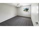 This bedroom is bright with neutral walls, carpet, ceiling fan, and a window overlooking the street at 281 Covent Gardens Pl, Deltona, FL 32725