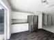 Bright eat-in kitchen with stainless steel appliances, white cabinets, and dark wood flooring at 281 Covent Gardens Pl, Deltona, FL 32725