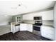 Updated kitchen with stainless steel appliances, granite countertops, and white cabinets at 281 Covent Gardens Pl, Deltona, FL 32725