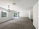 Spacious living room with neutral walls, carpet, recessed lighting, chandelier, and sliding glass door at 281 Covent Gardens Pl, Deltona, FL 32725
