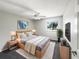 Cozy main bedroom featuring a ceiling fan, a large window, and soft, neutral decor at 281 Covent Gardens Pl, Deltona, FL 32725