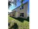 Side of the home featuring a grassy backyard and rear windows at 402 Big Sioux Ct, Kissimmee, FL 34759