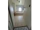Bathroom featuring a soaking tub beneath an arched window, plus tiled floors and a vanity at 402 Big Sioux Ct, Kissimmee, FL 34759