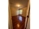 Bright bedroom featuring hardwood floors and a sunlit window at 402 Big Sioux Ct, Kissimmee, FL 34759