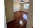 Bedroom with hardwood floors, ceiling fan, and a sunlit window at 402 Big Sioux Ct, Kissimmee, FL 34759