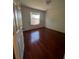 Bedroom with a window view and rich, dark hardwood flooring at 402 Big Sioux Ct, Kissimmee, FL 34759