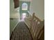 View down entryway with white staircase and tall window at 402 Big Sioux Ct, Kissimmee, FL 34759