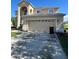 Exterior view of the two-car garage and driveway of this residence at 402 Big Sioux Ct, Kissimmee, FL 34759