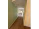 Narrow hallway featuring durable tile flooring connecting the main areas of the house at 402 Big Sioux Ct, Kissimmee, FL 34759