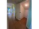 Hallway featuring a storage closet with durable tile flooring connecting the main areas of the house at 402 Big Sioux Ct, Kissimmee, FL 34759