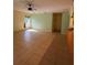 Spacious living room featuring tile floors, neutral paint, and a ceiling fan at 402 Big Sioux Ct, Kissimmee, FL 34759