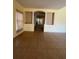 Open-concept living space with tile flooring, featuring an arched entryway and ample natural light at 402 Big Sioux Ct, Kissimmee, FL 34759