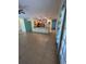 Open-concept living room and kitchen with tile floors and modern stainless steel appliances at 402 Big Sioux Ct, Kissimmee, FL 34759