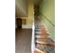 Staircase with wooden railing and steps leading to the upper level of the home at 402 Big Sioux Ct, Kissimmee, FL 34759