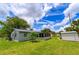 Large backyard featuring a storage shed and an enclosed porch, surrounded by a well-maintained lawn at 4469 Evers Pl, Orlando, FL 32811