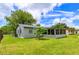 Spacious backyard with well-kept lawn and rear view of home with enclosed porch at 4469 Evers Pl, Orlando, FL 32811