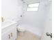 Updated bathroom featuring new vanity, sink, and walk-in shower with white tile and brushed gold accents at 4469 Evers Pl, Orlando, FL 32811
