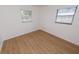 This bedroom is bright with a laminate floor and two windows at 4469 Evers Pl, Orlando, FL 32811