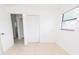 Bright bedroom features tiled floor, closet, and window for natural light at 4469 Evers Pl, Orlando, FL 32811