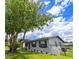 Charming single-story home with a well-manicured lawn, wrought iron fence, and mature shade tree at 4469 Evers Pl, Orlando, FL 32811