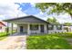 Inviting single-story home featuring a covered carport, a well-maintained lawn, and tasteful landscaping at 4469 Evers Pl, Orlando, FL 32811