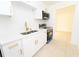 Bright kitchen with white cabinets, gold hardware, and stainless steel appliances, offers a clean, modern look at 4469 Evers Pl, Orlando, FL 32811